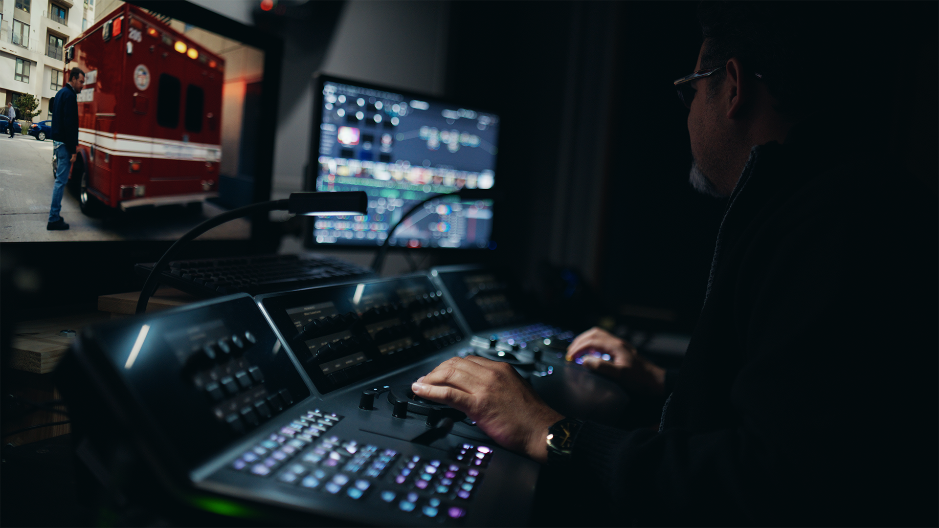 A DigitalFilm Tree colorist working in a darkened edit suite